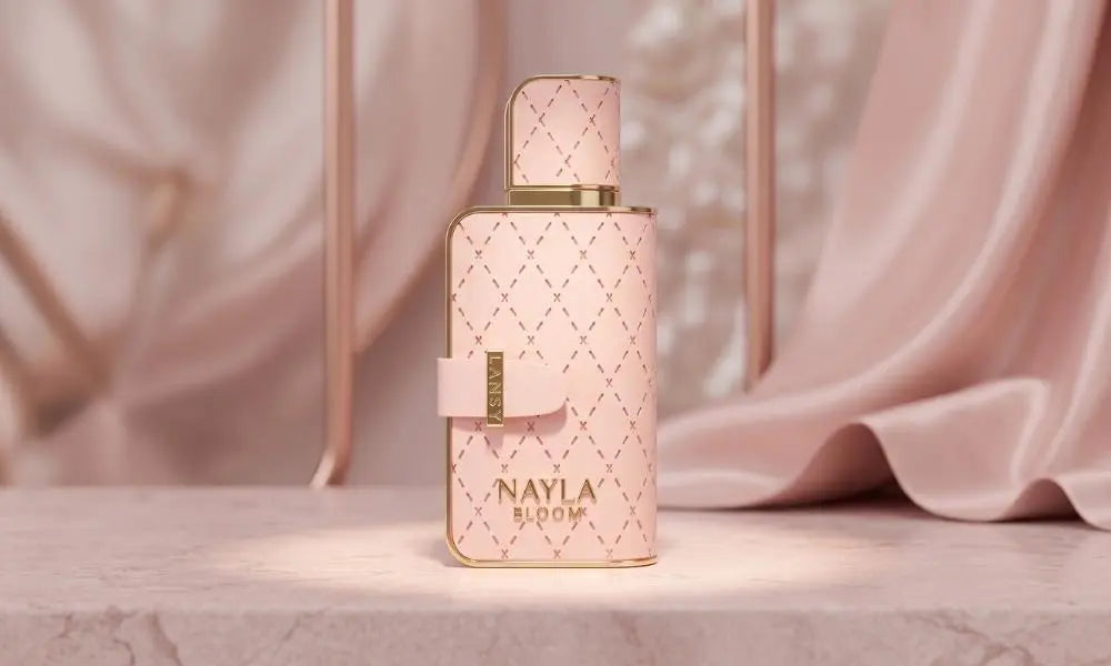 A quilted pink and gold LANSY "NAYLA BLOOM" perfume bottle on a pink marble table.