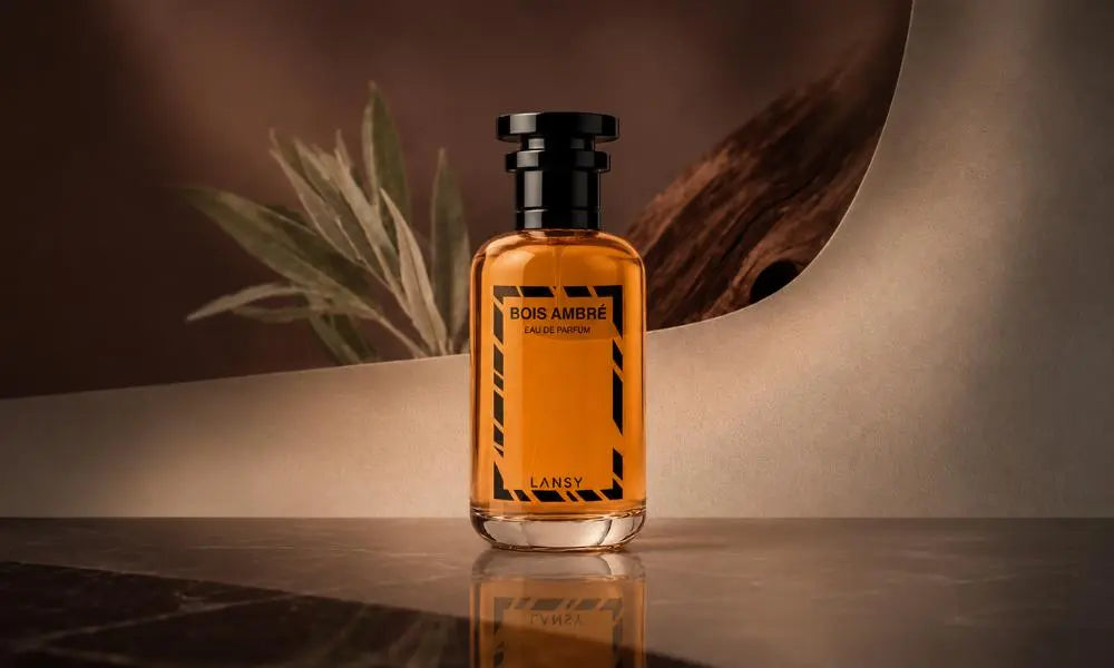 Luxury BOIS AMBRÉ Eau de Parfum bottle on a dark marble surface with warm ambient lighting, minimalist architectural backdrop, and elegant woody-inspired styling.