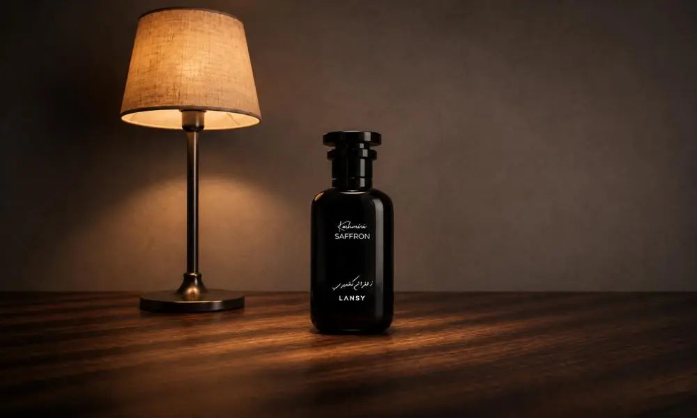 LANSY Kashmiri Saffron perfume bottle beside a warm table lamp.