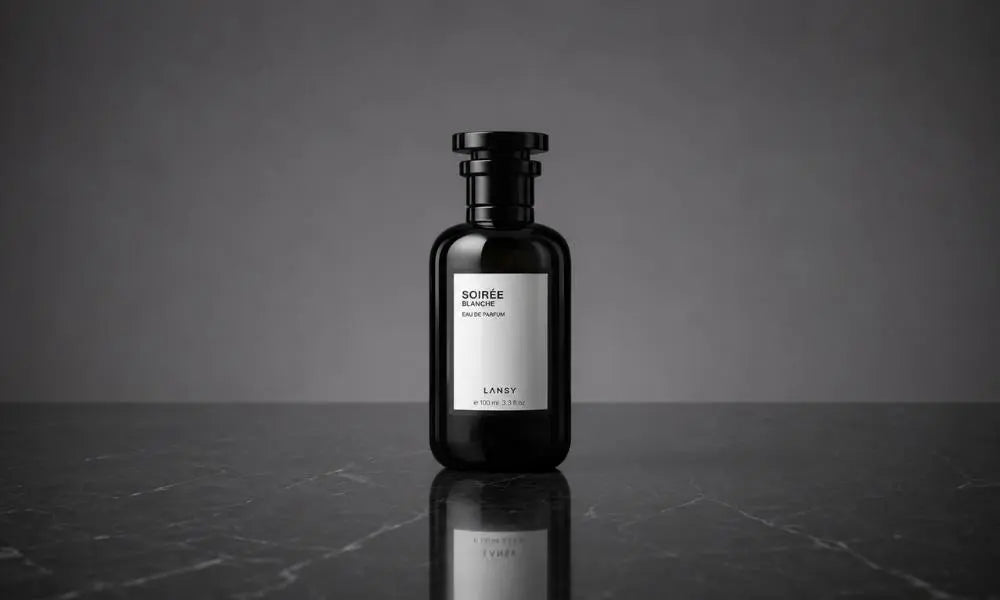 A centered photograph of a black "SOIREE BLANCHE" perfume bottle, on a dark marble plinth