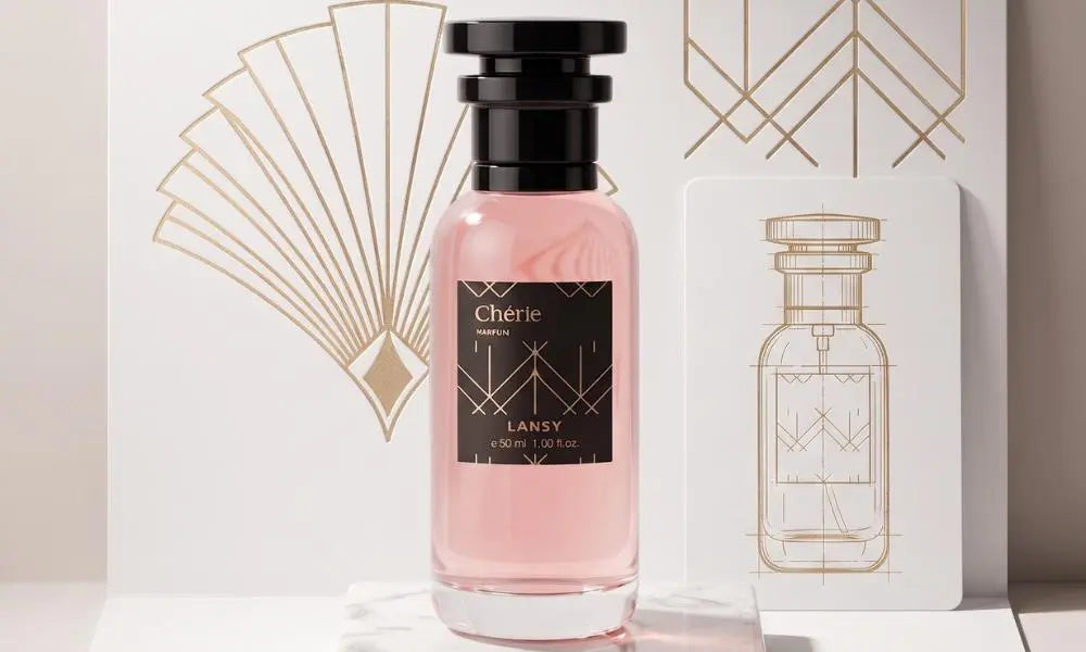 a perfume bottle with pink liquid on a white marble stand, next to a white card with a gold line drawing.