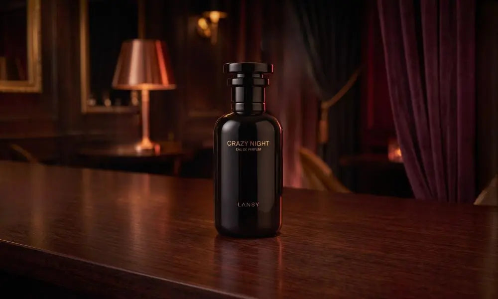 Elegant black bottle of Lansy "Crazy Night" perfume on a polished dark wood bar counter in a dimly lit, moody lounge.