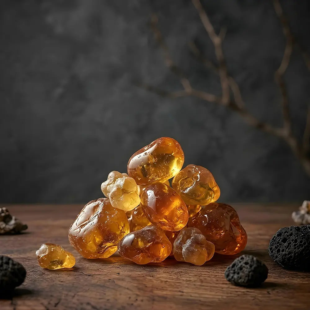 Stack of amber-colored stones on a wooden surface with a dark background