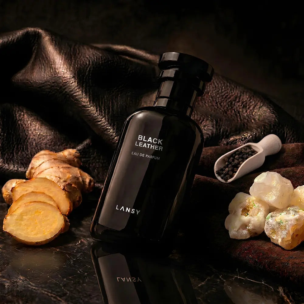 Lansy Black Leather perfume bottle on a dark surface with natural elements.