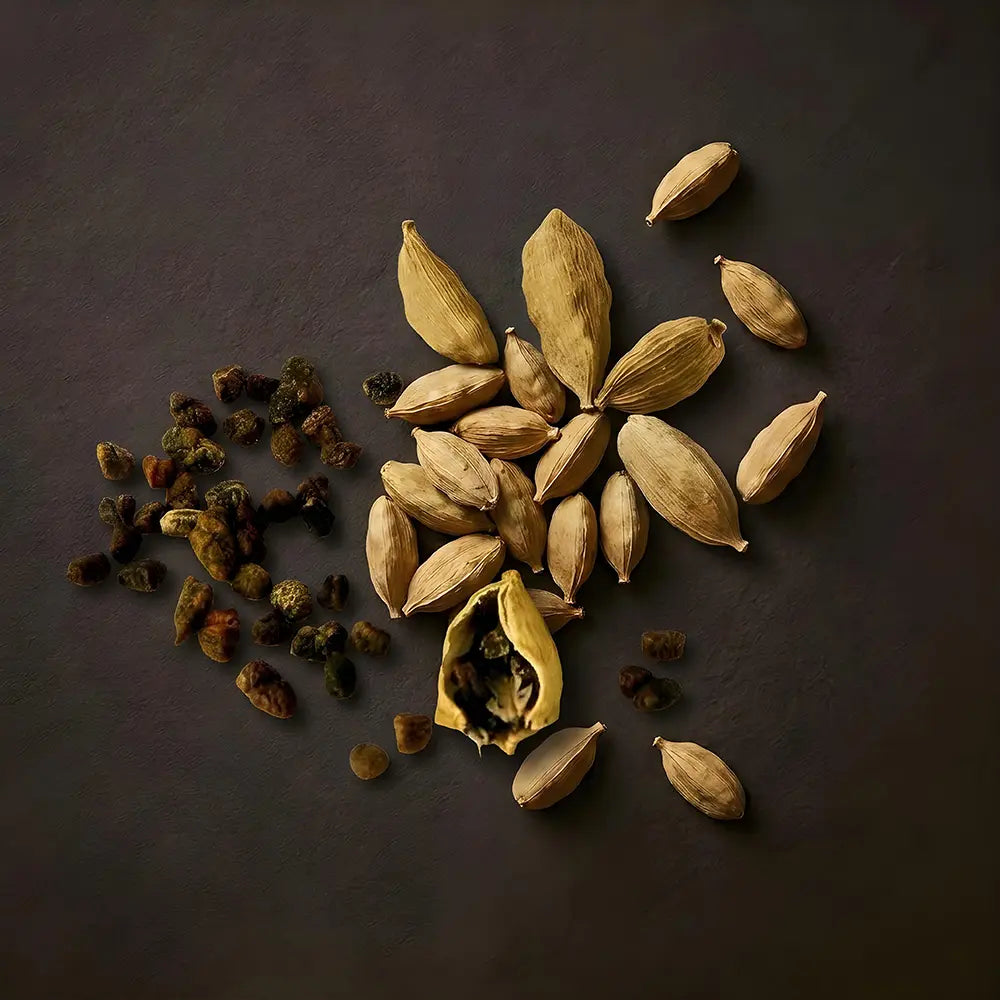 Cardamom pods on a dark surface