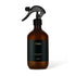 Brown spray bottle with black label on a white background