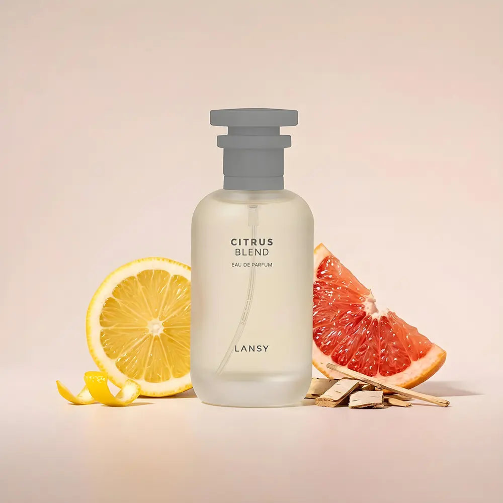 Lansy Citrus Blend perfume bottle with lemon and grapefruit slices on a beige background