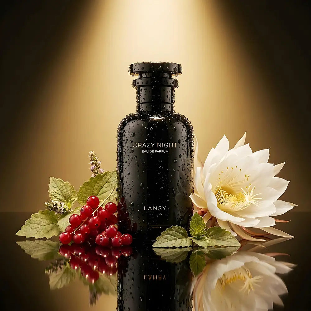 Black perfume bottle labeled 'Crazy Night' by LANSY with red berries and a white flower on a reflective surface.