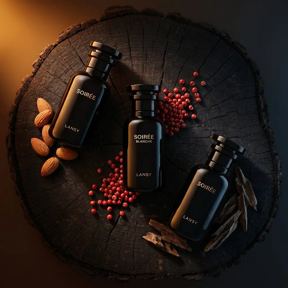 Three Lansy Soirée Blancée perfume bottles arranged on a dark wood log slice with almonds, red berries, and cinnamon sticks.