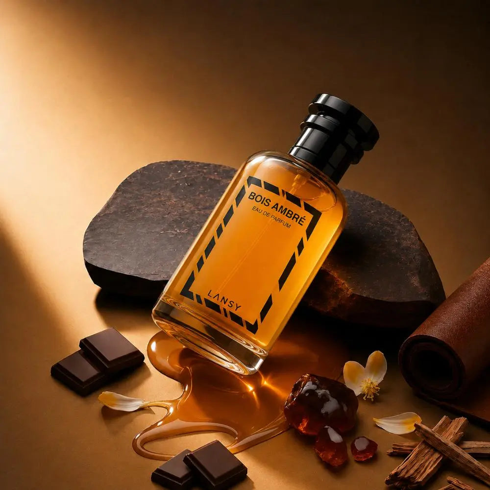 Bois Ambre Eau de Parfum with chocolate, cinnamon and flowers on a warm brown background.