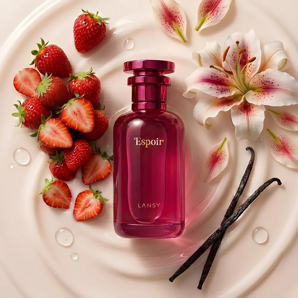 Espoir perfume with strawberries, flowers and vanilla beans on a white plate.