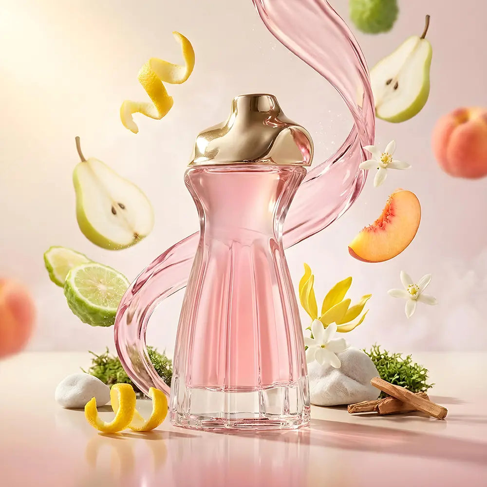 LANSY I’m The Lady pink perfume bottle with fruit and flowers on a light background.