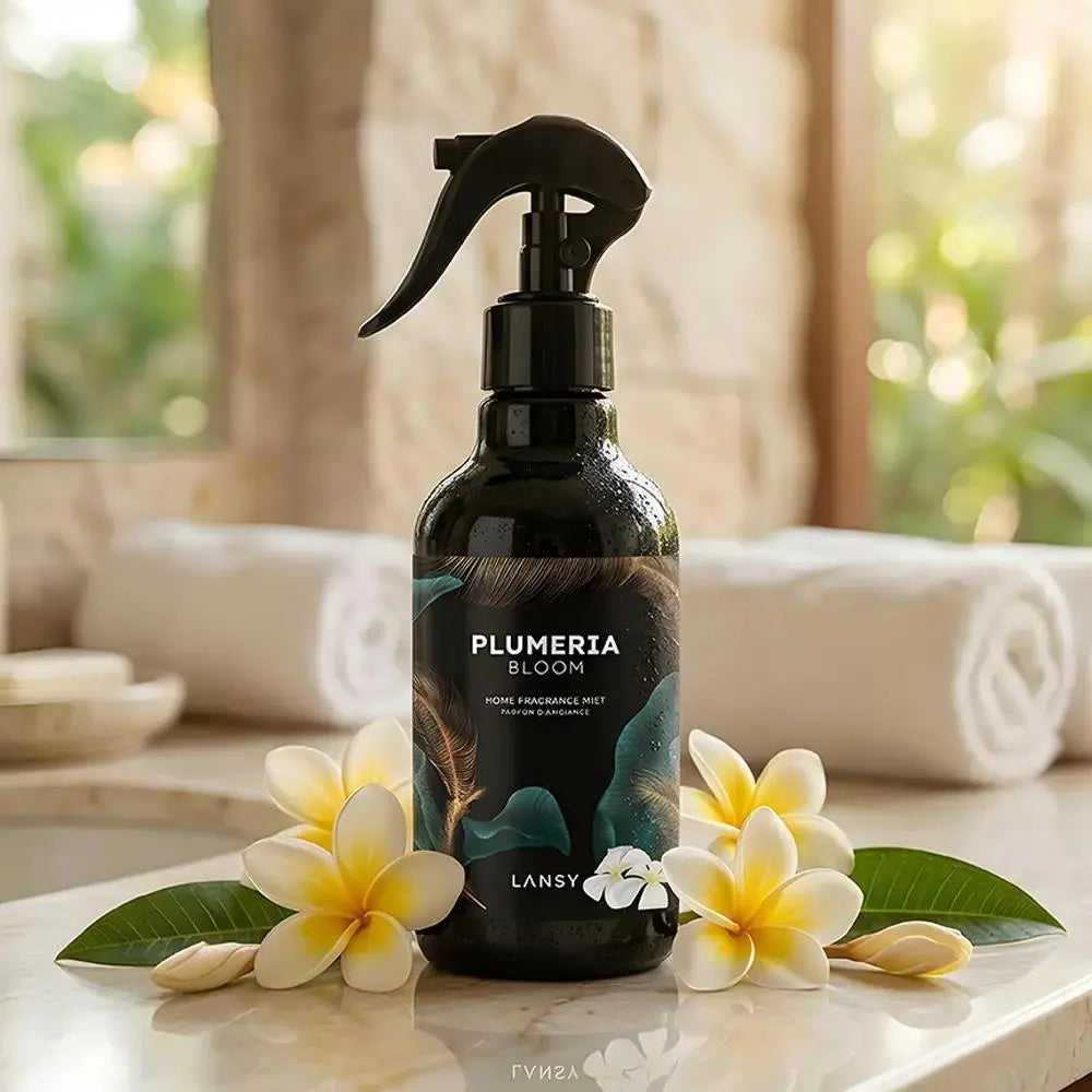 Plumeria Bloom mist with white and yellow flowers on a marble surface.