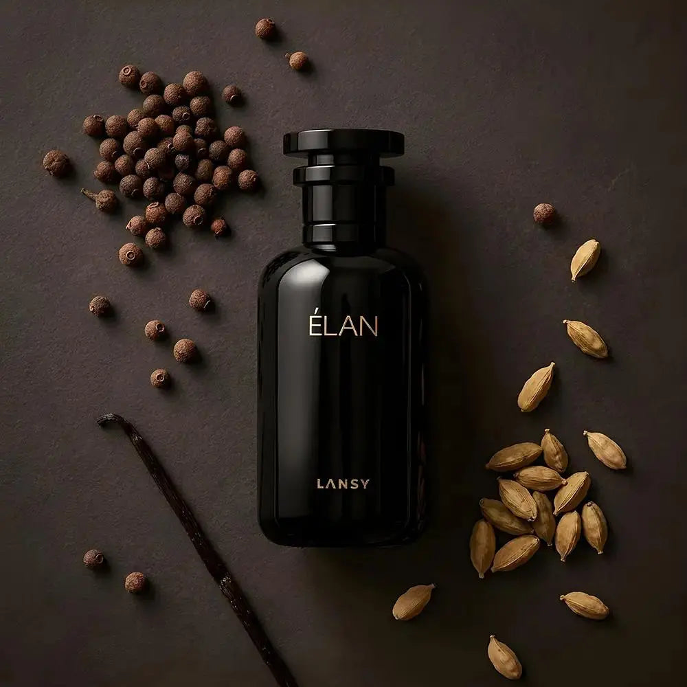 Black LANSY ÉLAN perfume bottle surrounded by spices on a dark surface