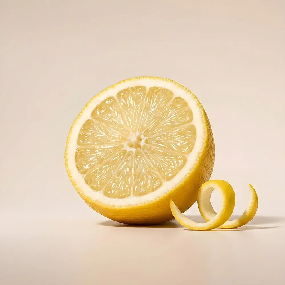 Halved lemon with a peel on a beige background