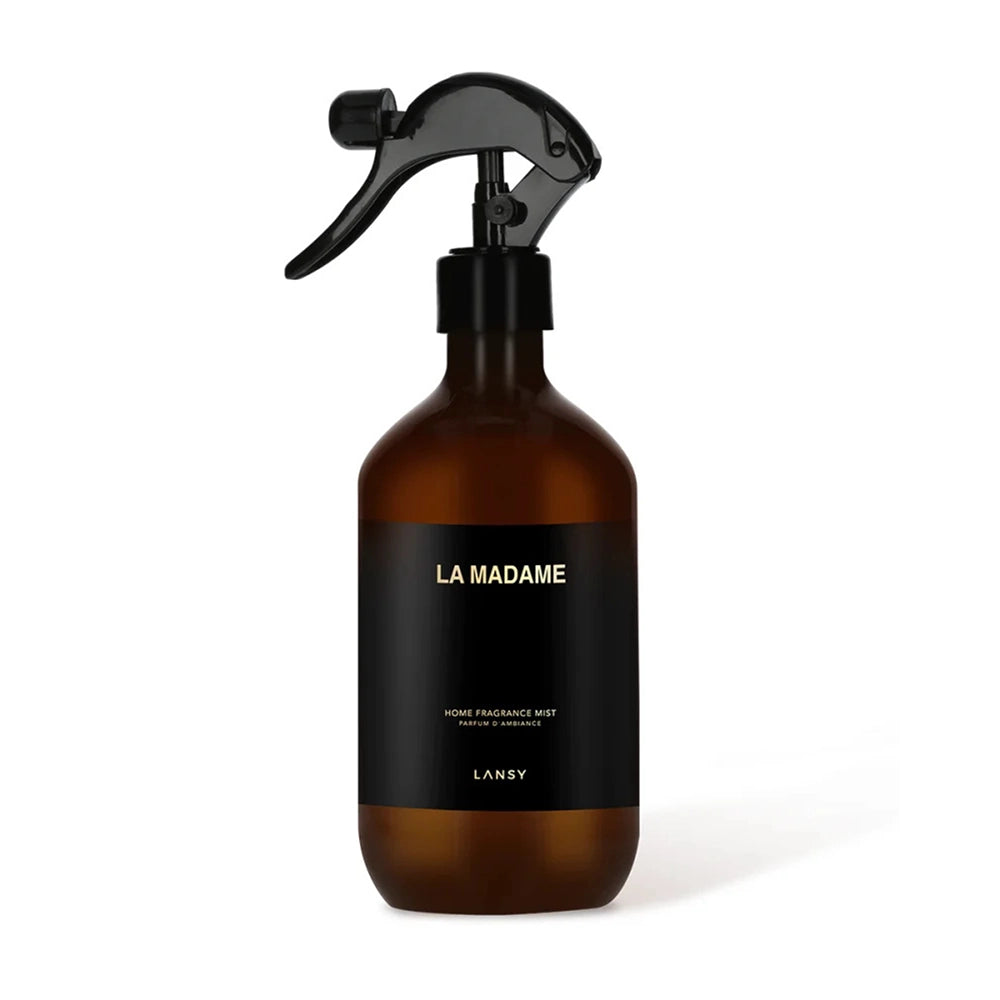Brown spray bottle with black label on a white background