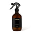 Brown spray bottle with black label on a white background