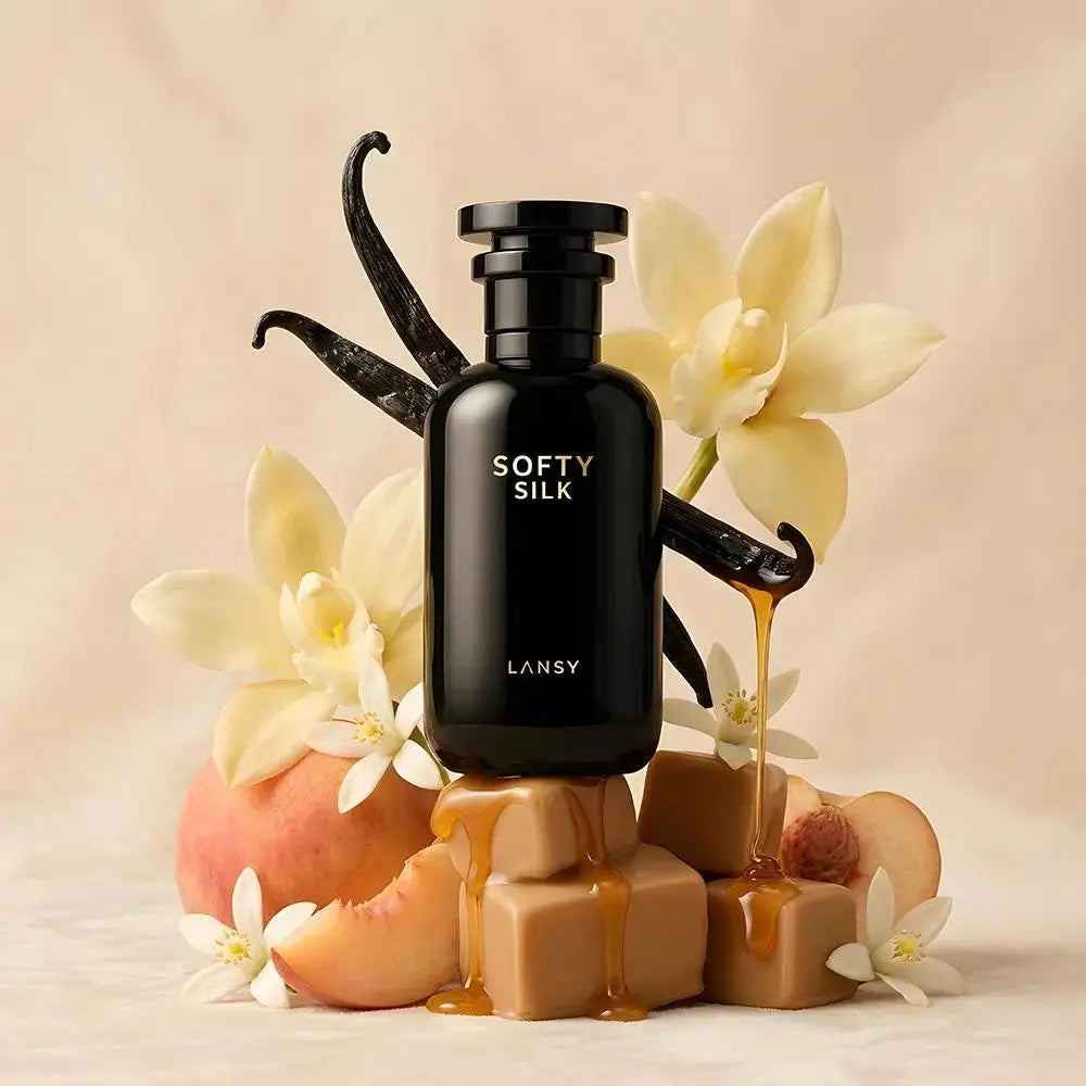 LANSY Softy Silk perfume bottle with vanilla beans, peach slices and flowers on a beige background.