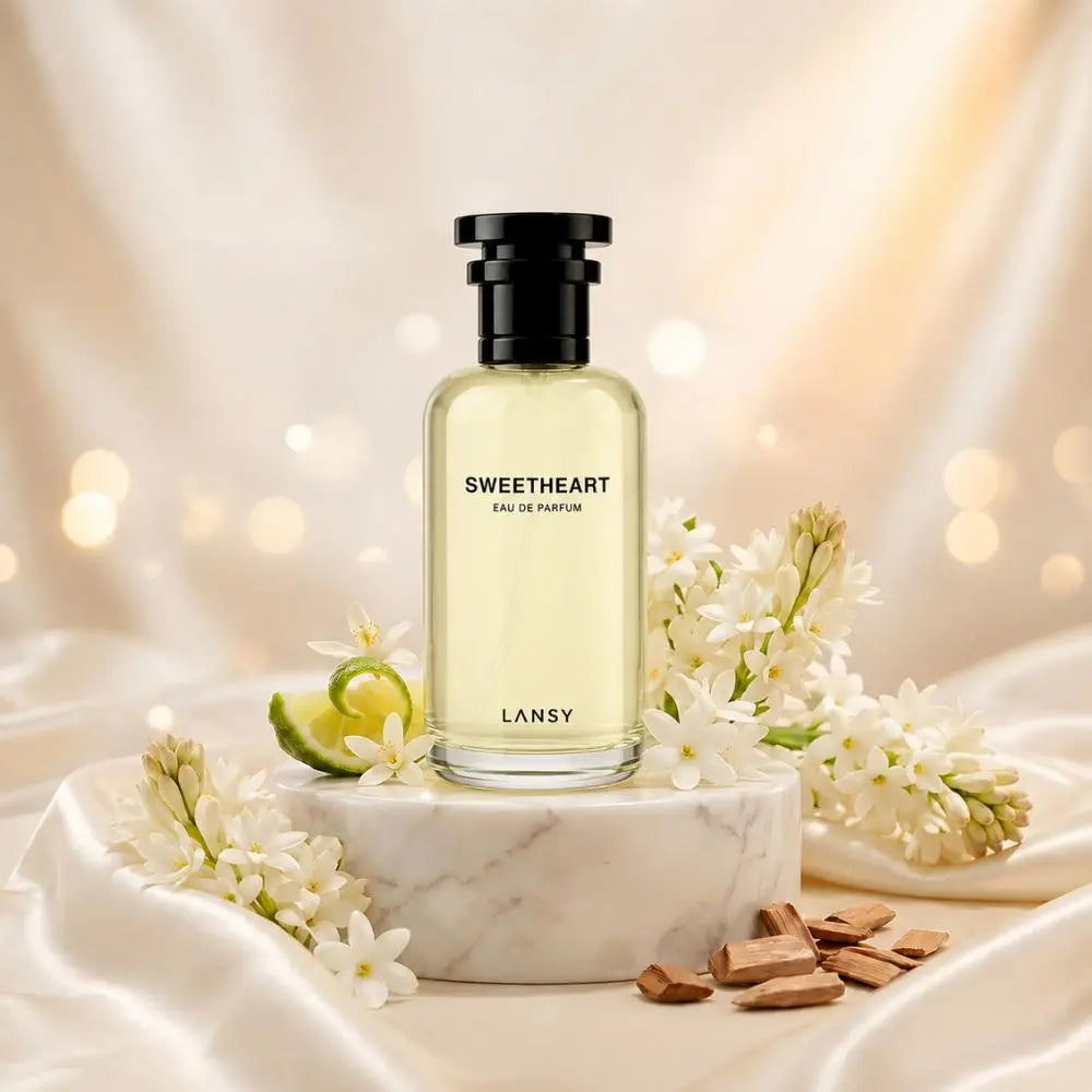 LANSY Sweetheart Eau de Parfum with white flowers, lime and chocolate on a marble pedestal.