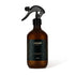 Brown spray bottle with black label on a white background
