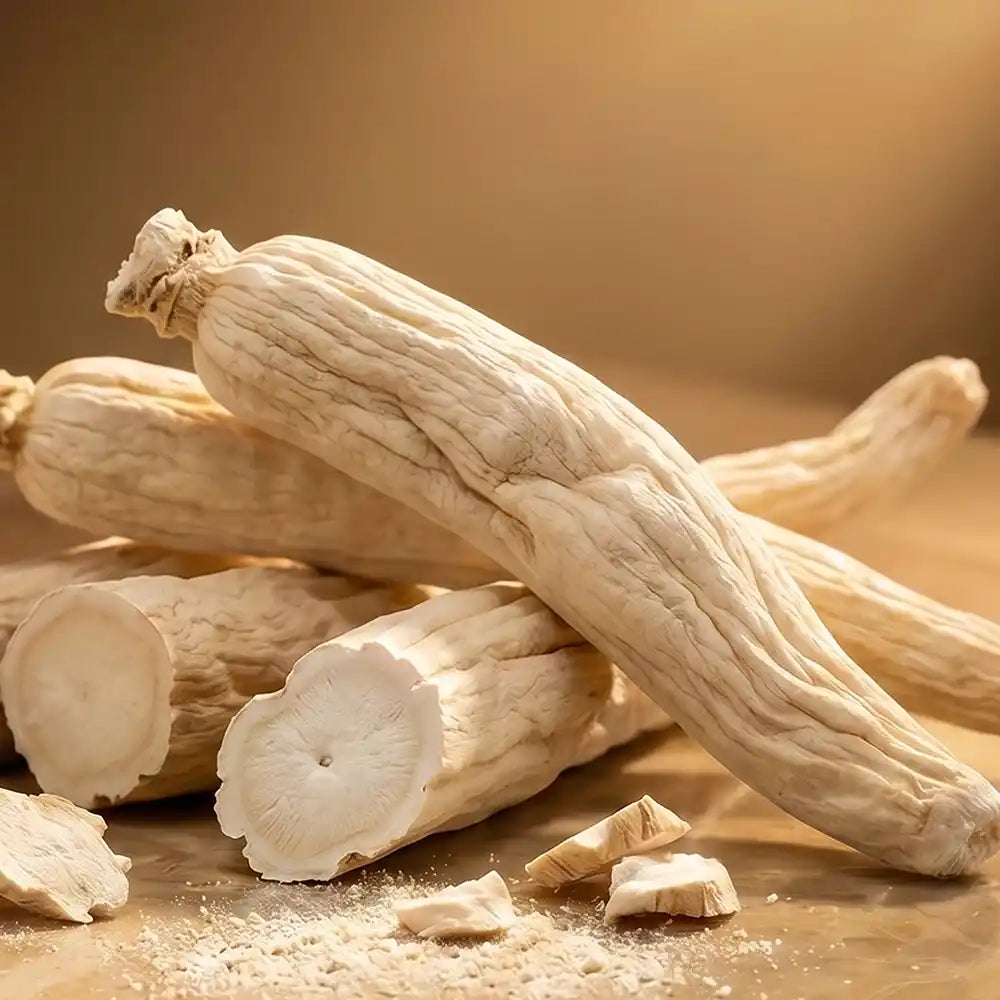 Dried orris roots with cut pieces and powder on a warm wooden surface.
