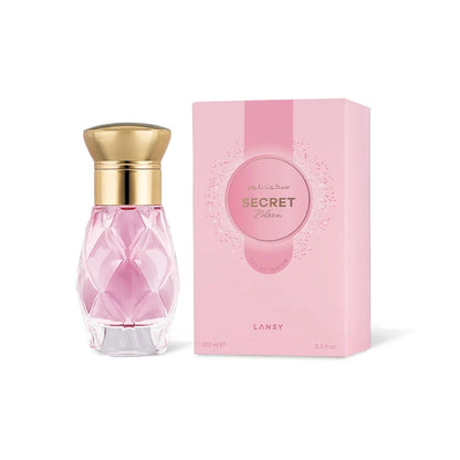 Pink perfume bottle with gold cap and matching pink box on a white background