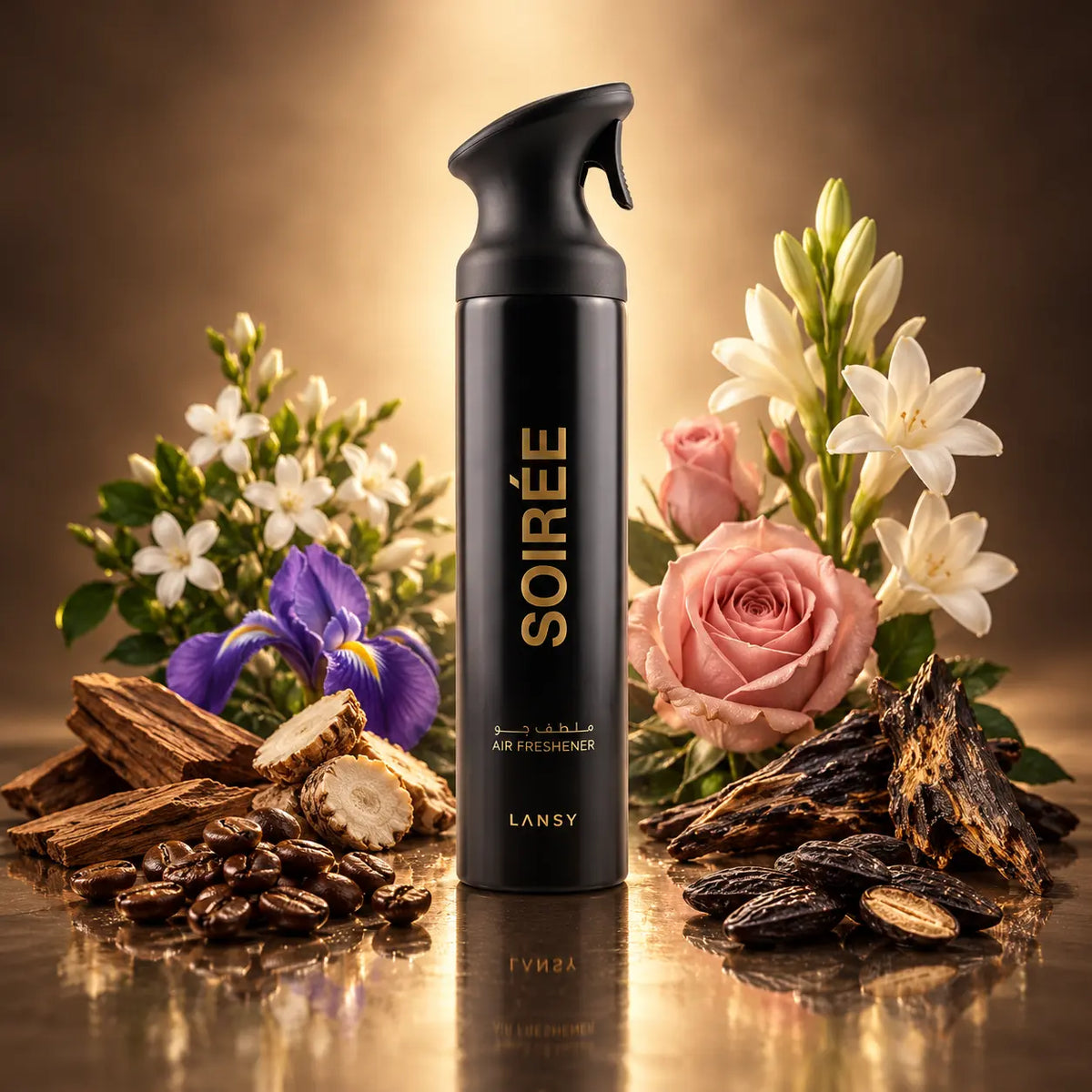 A black spray bottle labeled SOIRÉE by LANSY stands centered on a reflective gold surface, surrounded by flowers, wood pieces, coffee beans, and dark bark ingredients. The product is shown in a styled studio setup with no person or real environment.