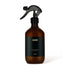 Brown spray bottle with black label on a white background